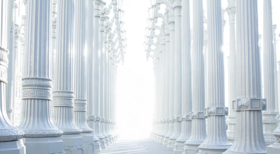 Bright white decorative image of large white columns in a line